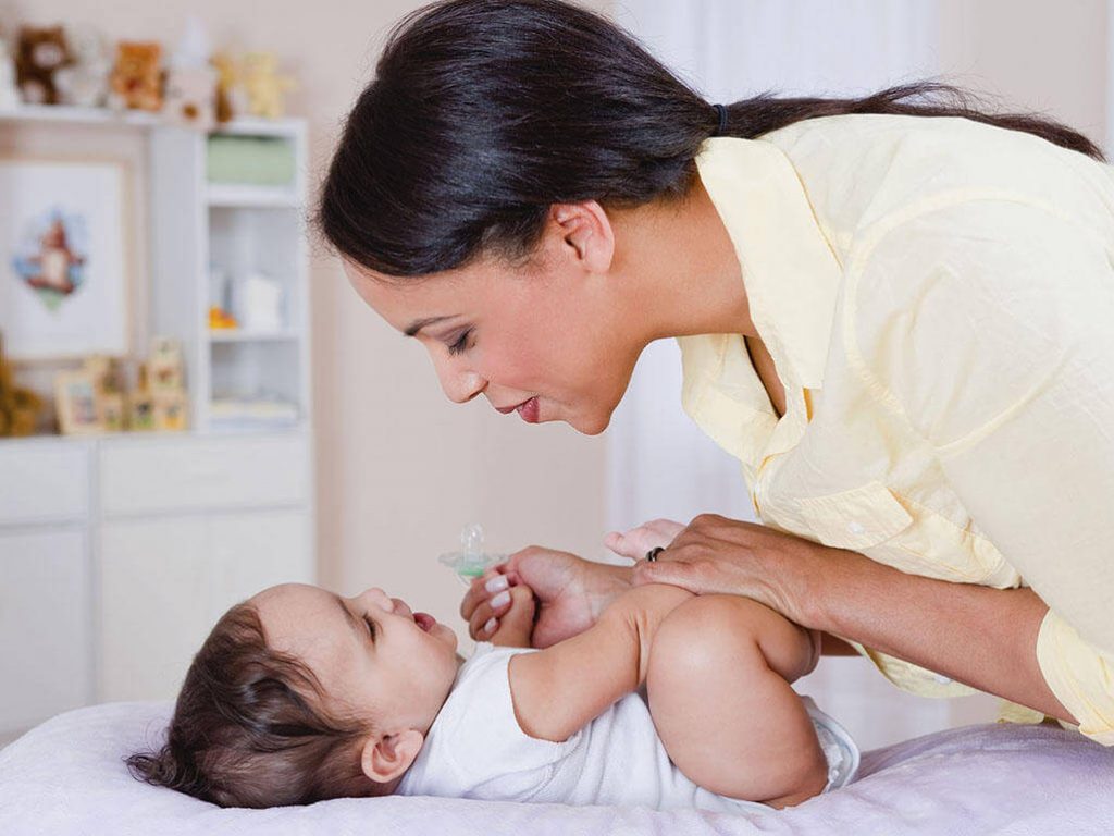 Maman qui chante à son bébé couché