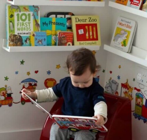 Un enfant en train de lire, ce qui peut aider à lui apprendre à parler