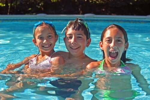Des enfants souriant dans une piscine