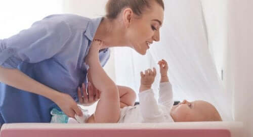 Une mère change la couche de bébé