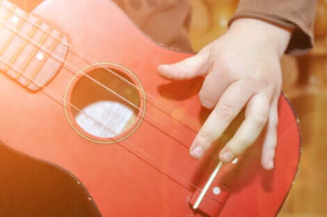 Un enfant qui joue de la guitare.