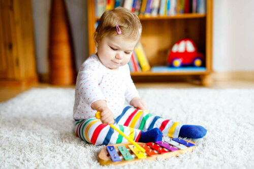 Un bébé qui joue au xylophone en musique.