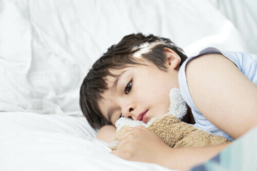 Un enfant couché au lit inquiet pendant une crise.