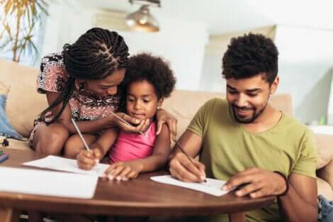 Deux parents qui aident leur jeune fille à faire ses devoirs. 