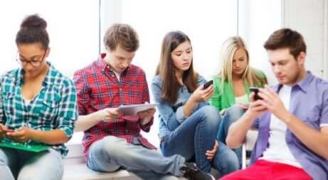 Un groupe d'adolescents accros à leur téléphone. 