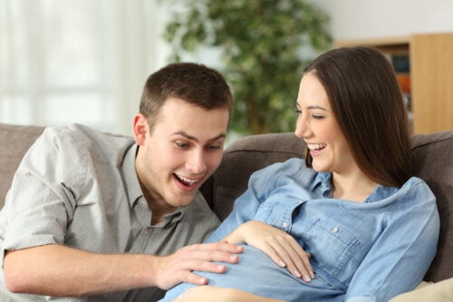 Des parents heureux qui parlent au bébé dans le ventre. 