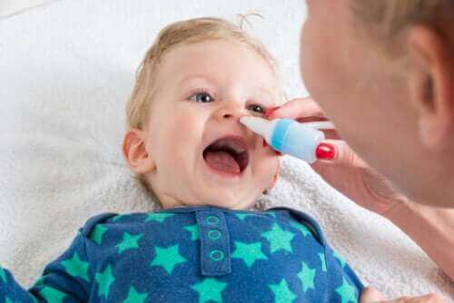 lavage nasal salin bébé main sein heureux sourire aspiré mucus