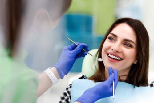 jeune fille assise dans une chaise de dentiste sourire heureux