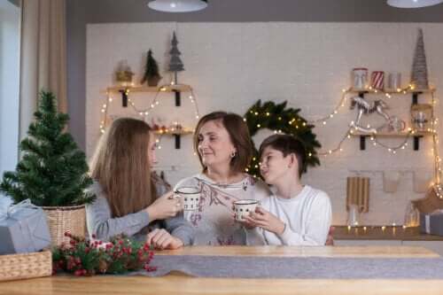 Mère avec ses enfants buvant du chocolat à Noël.