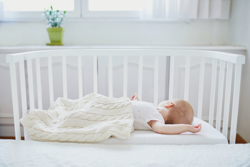 bébé dans un lit barreau